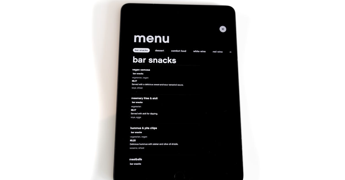Tablet displaying a digital menu for bar snacks in a modern, minimalistic style.
