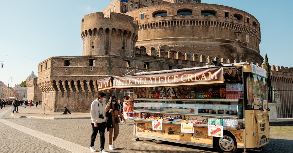 Tourists enjoy a stroll by an ice cream truck near Castel Sant'Angelo in Rome.