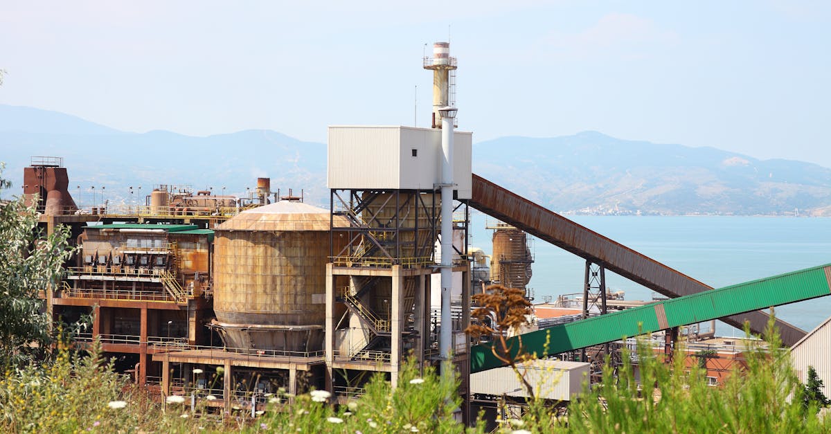 A scenic industrial plant located by the sea in Balıkesir, Turkey, under a clear sky.