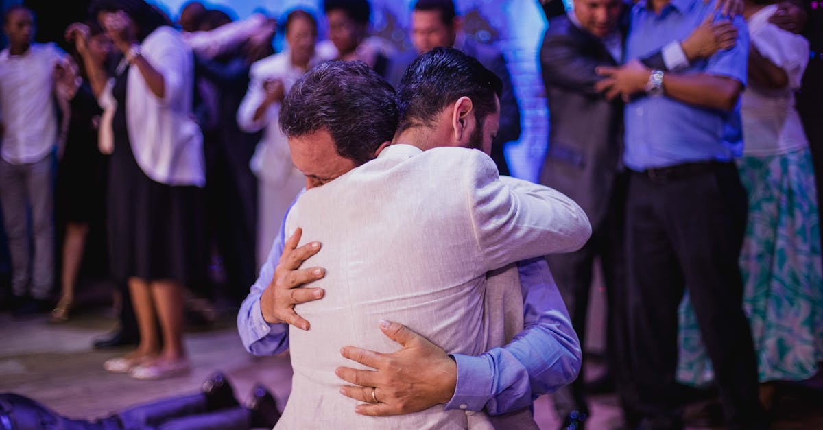 Two men embrace in a touching moment during a religious celebration.