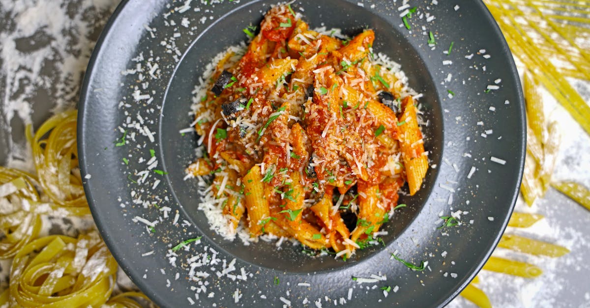 Tasty penne pasta in rich tomato sauce topped with Parmesan cheese and herbs.