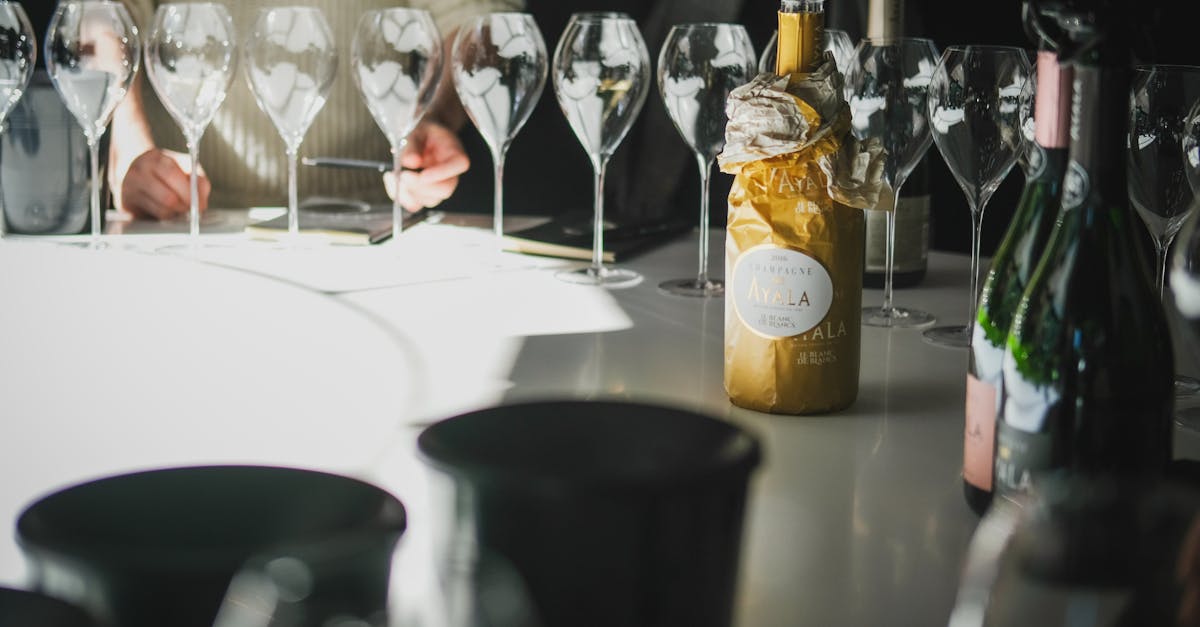 Chic champagne tasting with wine glasses and bottles in Aÿ, Grand Est, France.