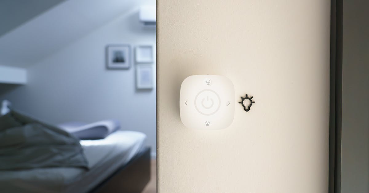 A minimalist bedroom featuring a smart home automation switch on the wall for controlling devices.