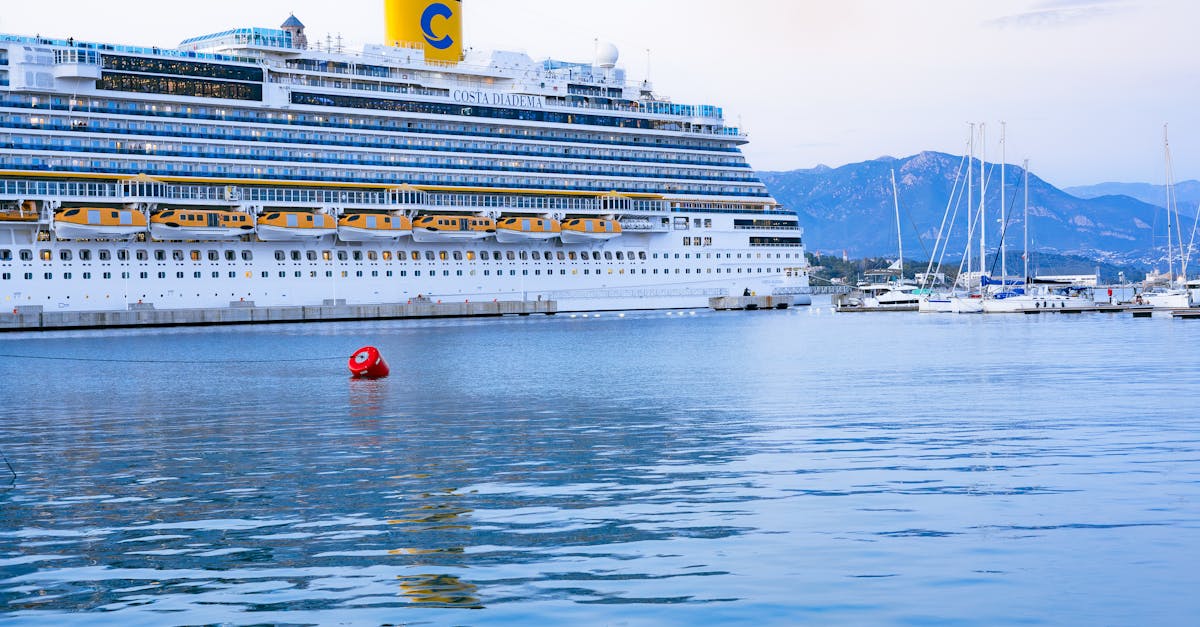 Stunning view of a cruise ship docked at Ajaccio port, Corsica with scenic mountain backdrop.