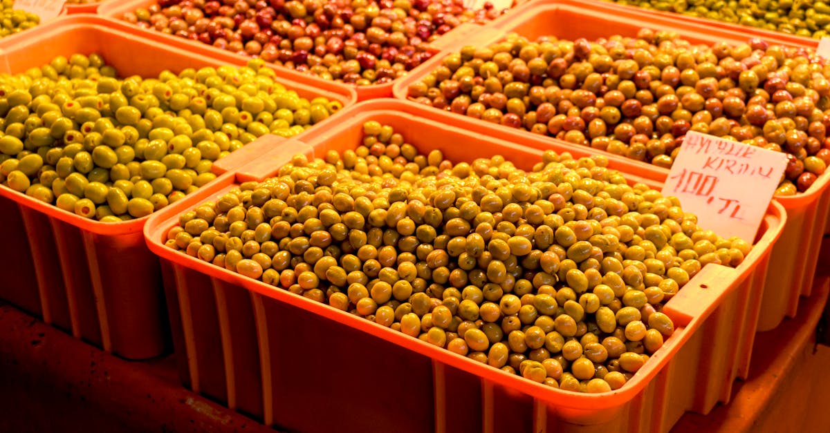 An array of fresh olives at a bustling street market, showcasing vibrant colors and abundance.