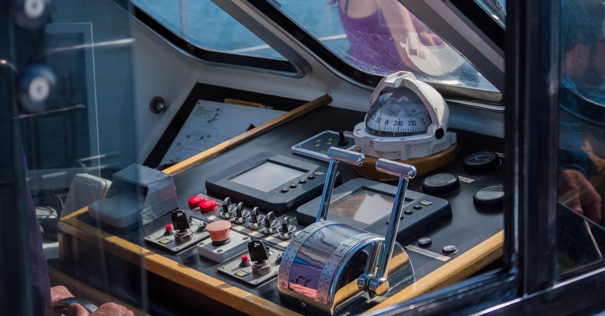 Close-up view of a ship's control console with navigational equipment, showcasing maritime technology.