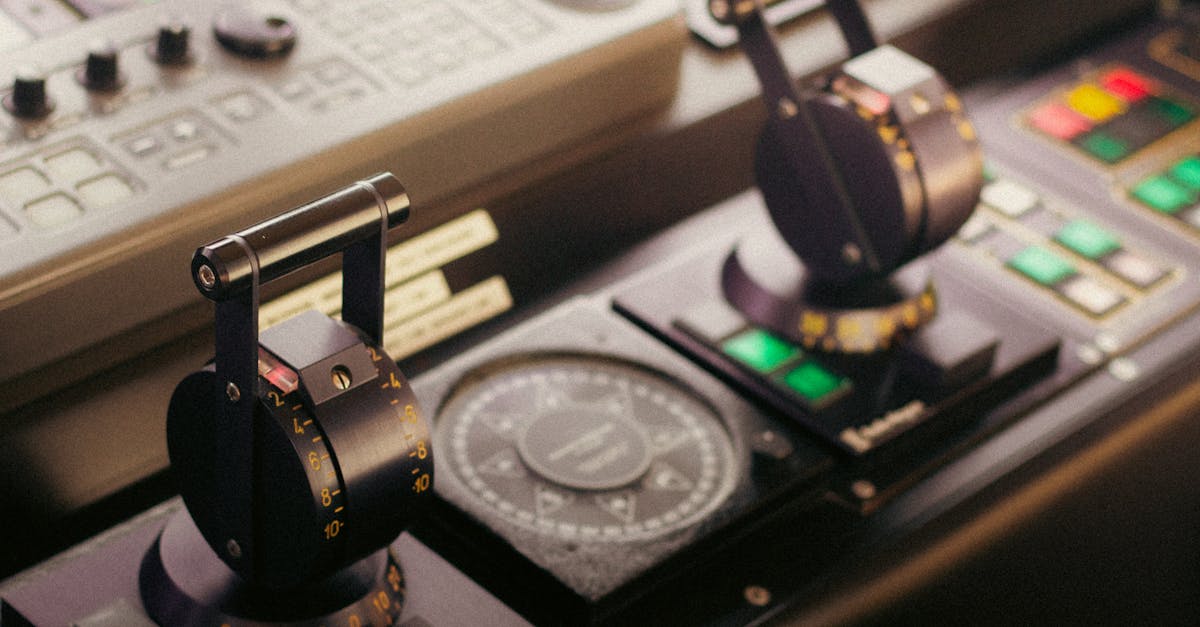 Detailed view of control levers and compass on a ship's bridge, showcasing navigational technology.