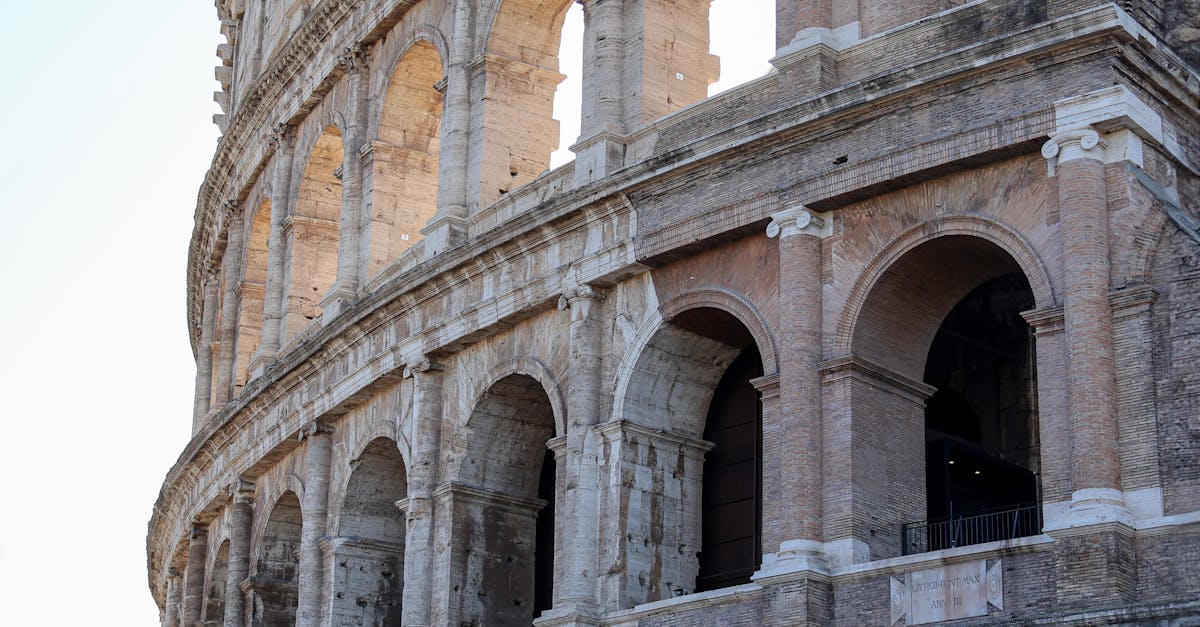 Detailed view of ancient Roman Colosseum arches in Rome, highlighting historical architecture.