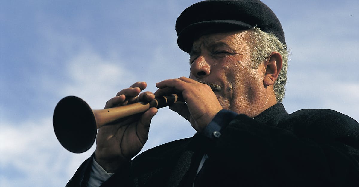 Elderly musician passionately plays traditional wind instrument outdoors in Erzurum, Turkey.