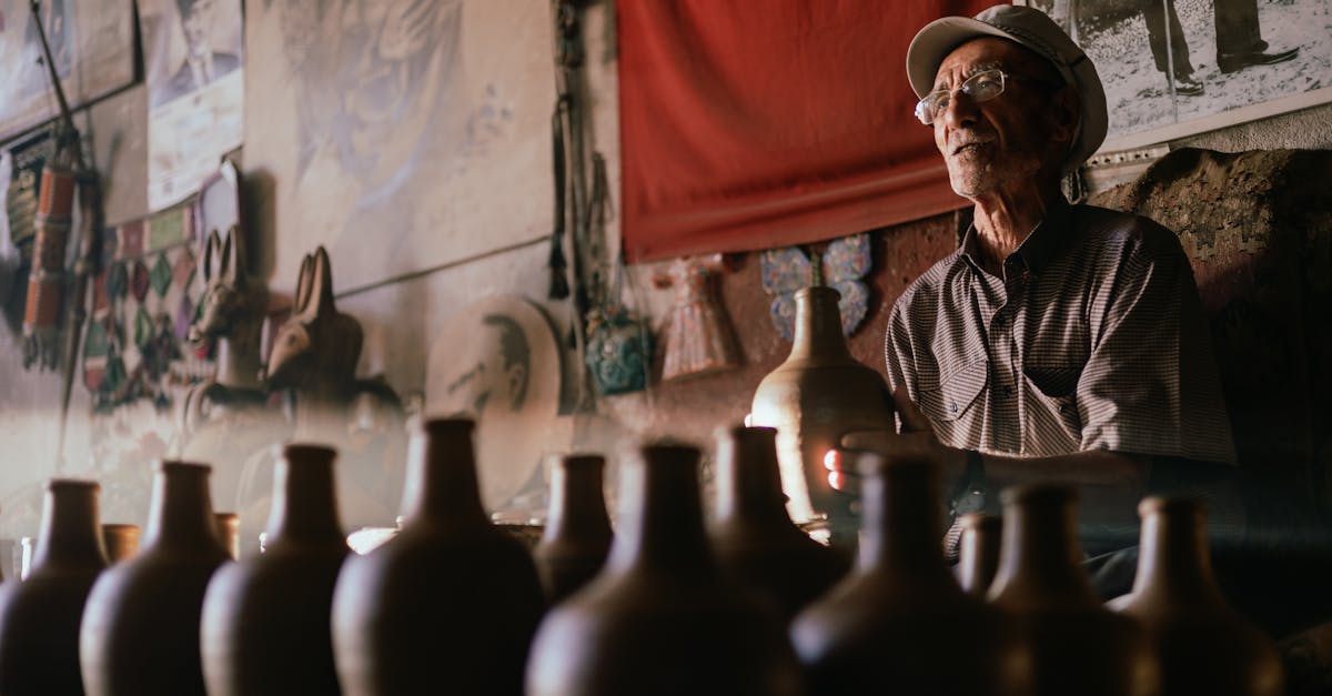 An artisan potter skillfully shaping earthen pots in a dimly lit Avanos workshop.
