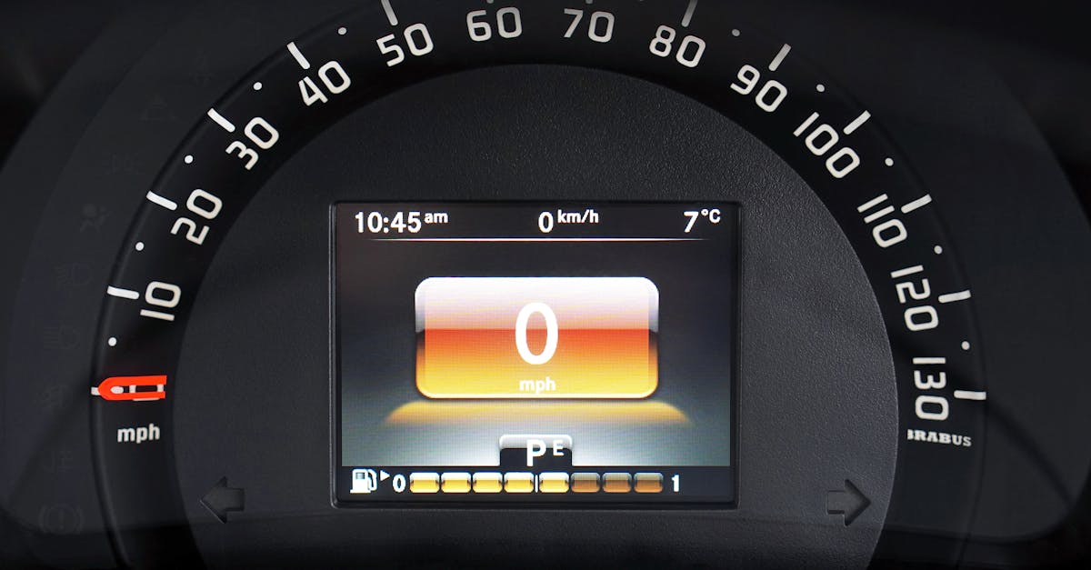 Close-up of a luxury car dashboard with a digital speedometer and sleek design features.