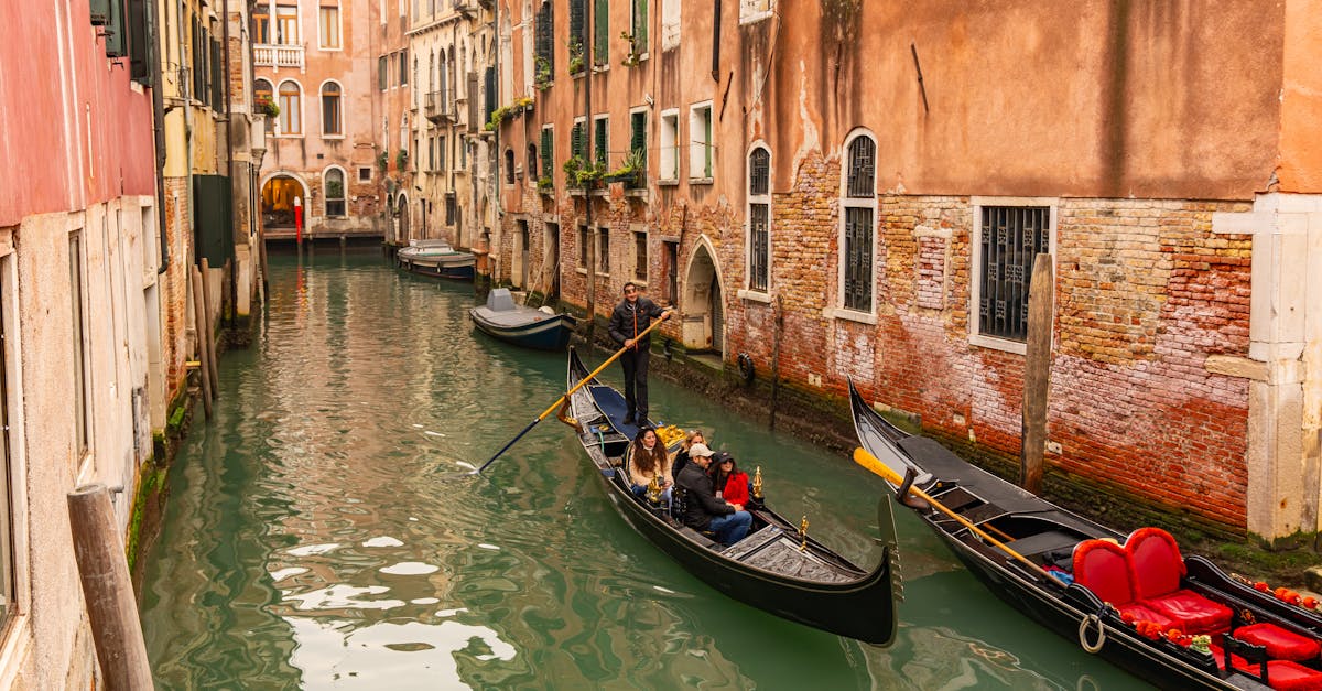 Gondolas on a charming Venetian canal surrounded by historic architecture in Venice, Italy.