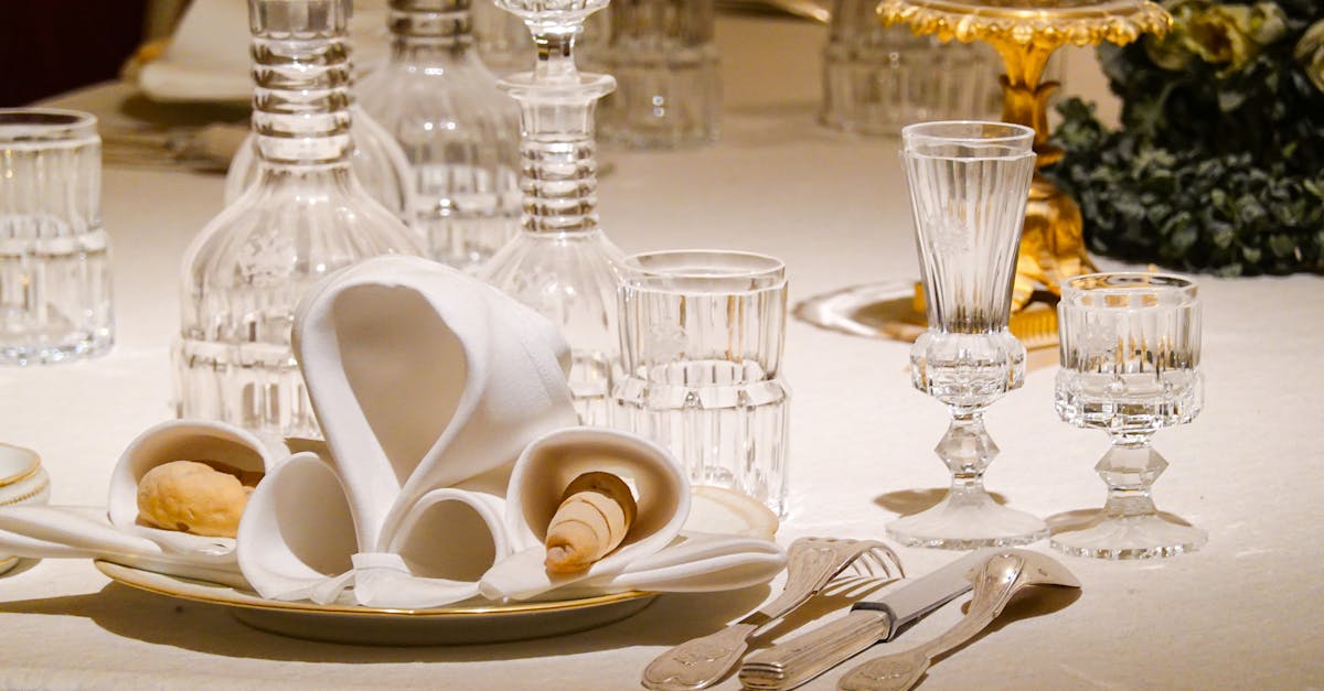 An elegantly set dining table with crystal glassware and ornate decor, ideal for formal occasions.