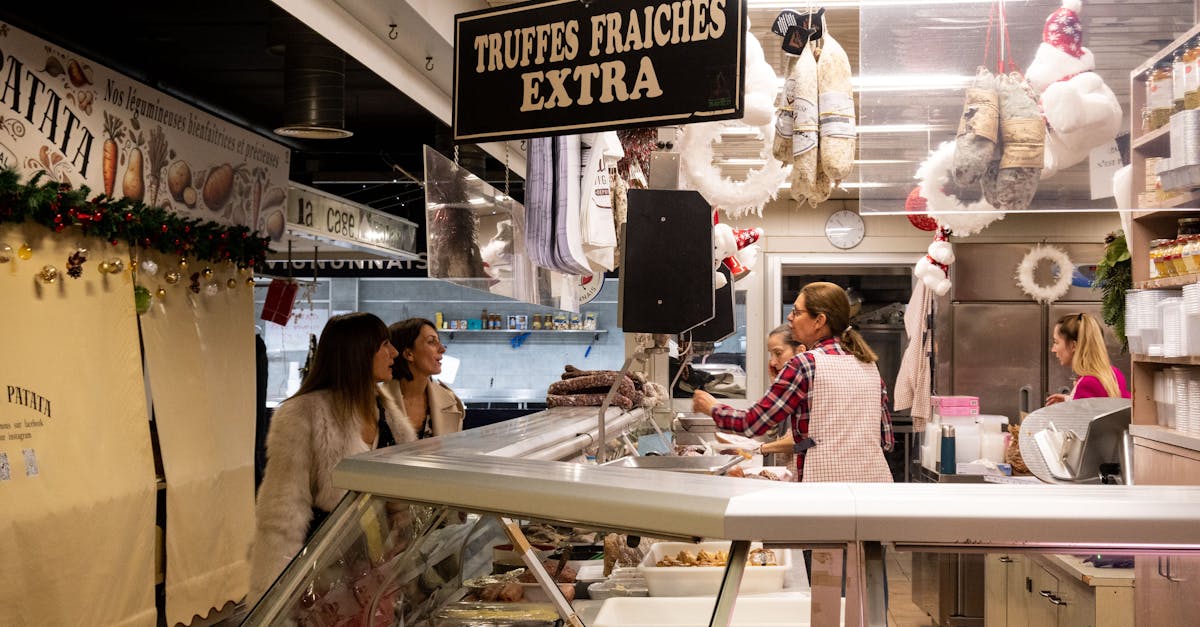 Indoor view of a crowded market stall in Avignon, France, selling fresh truffles.