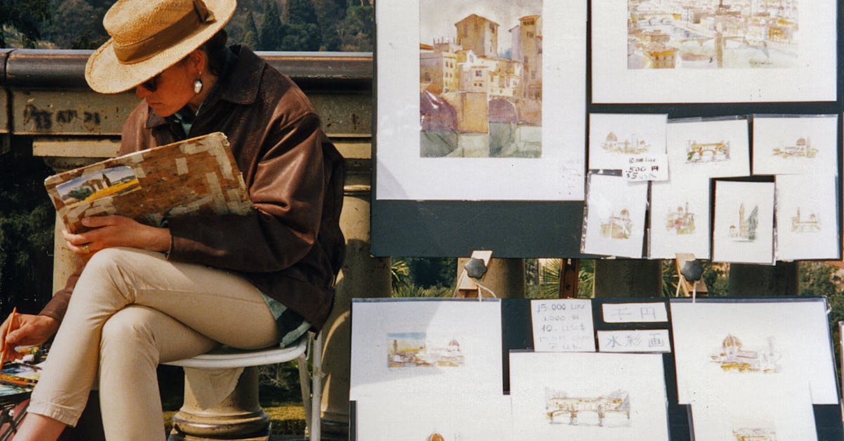A street artist capturing scenic Florence with watercolors. Artworks displayed on easel outdoors.