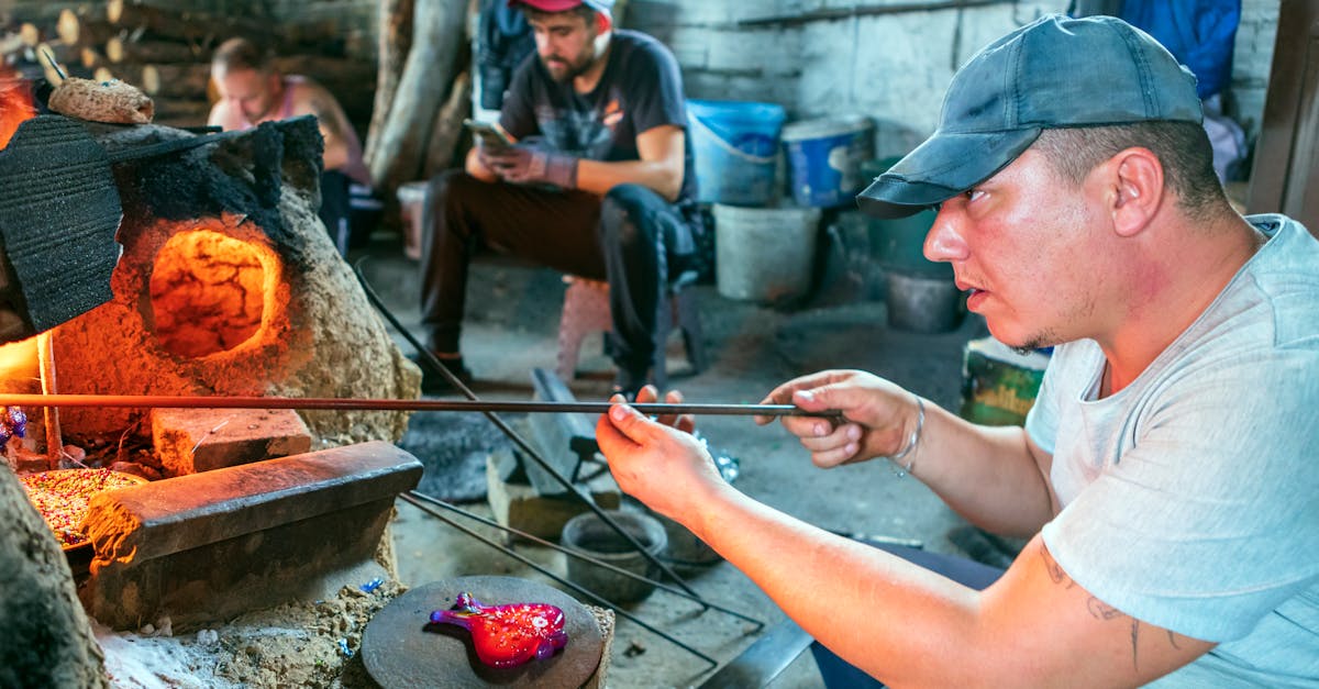 A skilled artisan glassblows a vibrant piece, surrounded by a traditional workshop setting.