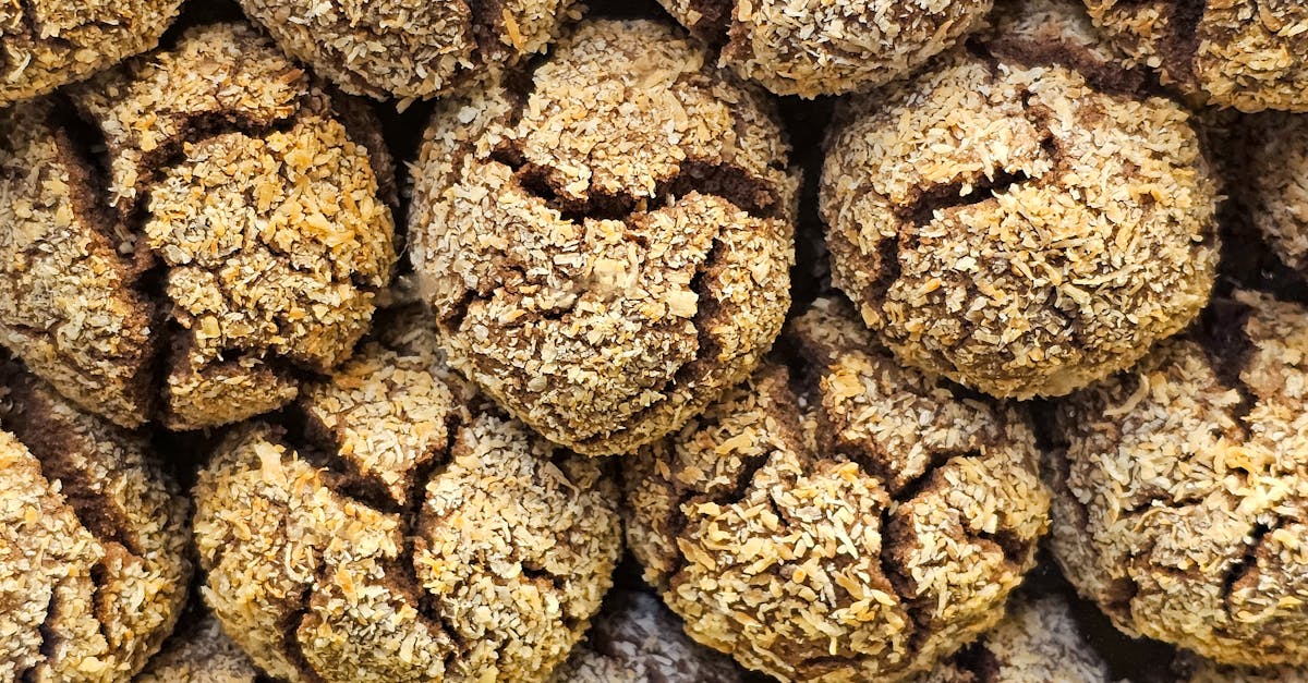 A detailed close-up of stacked crunchy coconut cookies showing texture and cracks.