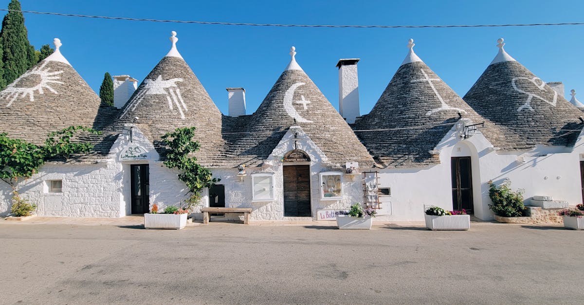 Trulli houses with conical roofs in Alberobello, Italy, on a sunny day.