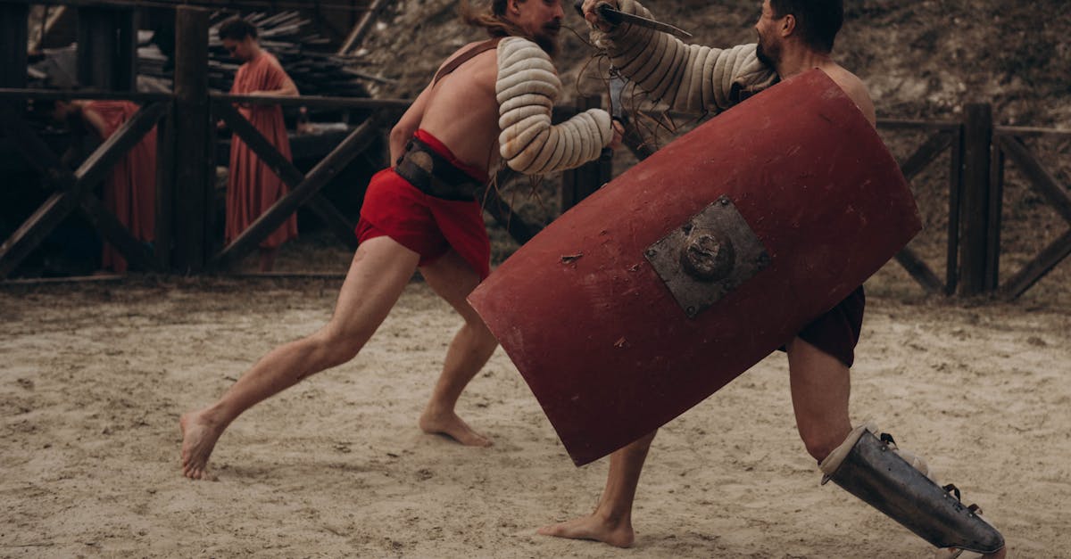 Two gladiators engaged in intense combat in a historical arena setting.