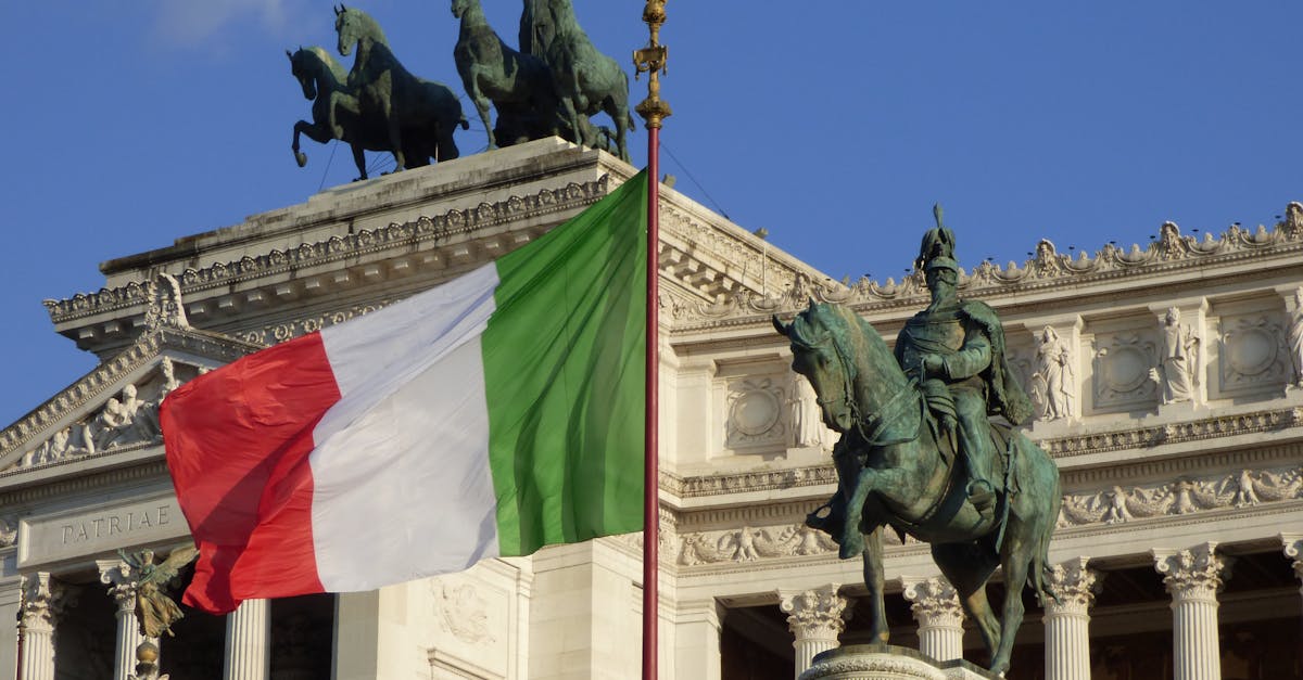 Italian flag waving at the Altare della Patria, showcasing Roman architecture and historical monuments.