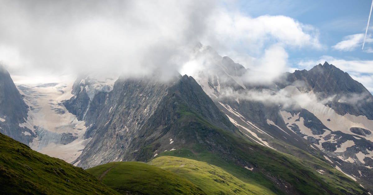 Stunning view of the snow-capped mountains in Obergurgl, Tirol, framed by dramatic clouds.