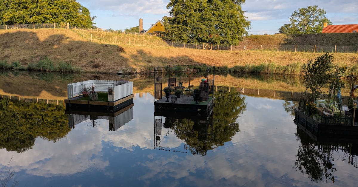 Floating gardens on a peaceful lake reflecting the sky, surrounded by lush countryside.