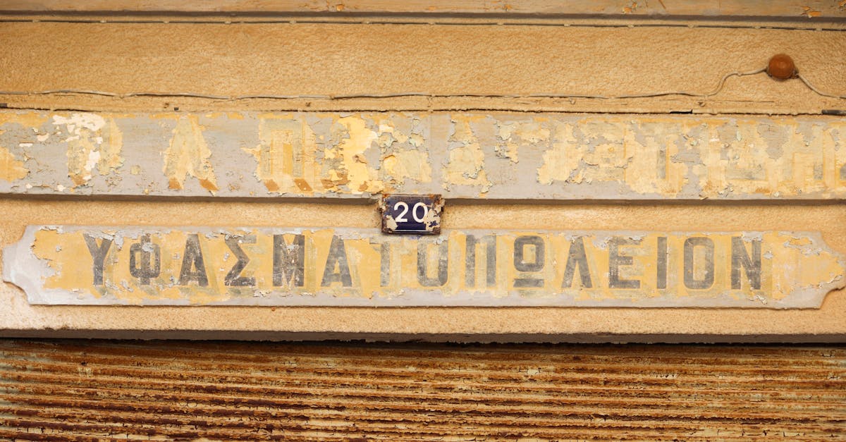 Aged shop sign with peeling paint in Gazimağusa, offering a vintage look.