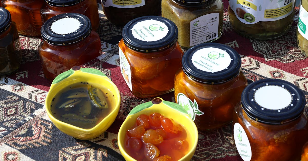 Colorful jars of homemade preserves and jams on a traditional patterned cloth.