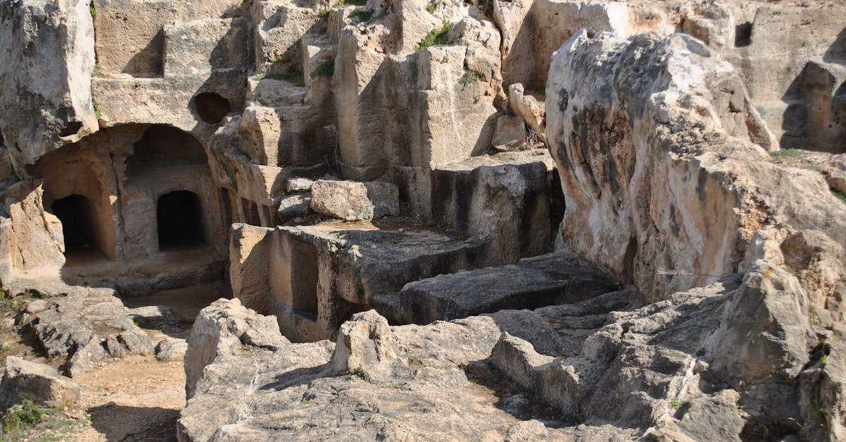 Explore the ancient rock-cut tombs in Cyprus, showcasing historical archaeology and rugged stone formations.