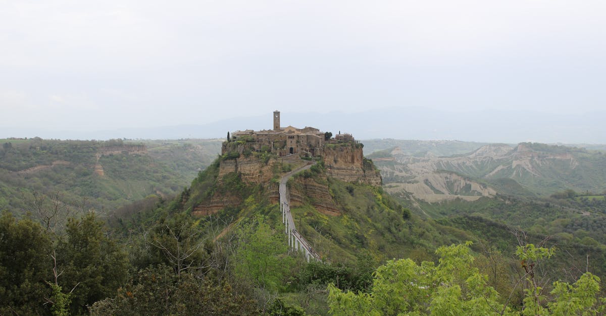 Explore Civita di Bagnoregio, an ancient hilltop village set against a scenic Italian landscape.