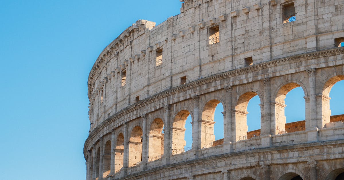 Capture of the iconic Colosseum in Rome, Italy, against a clear blue sky.