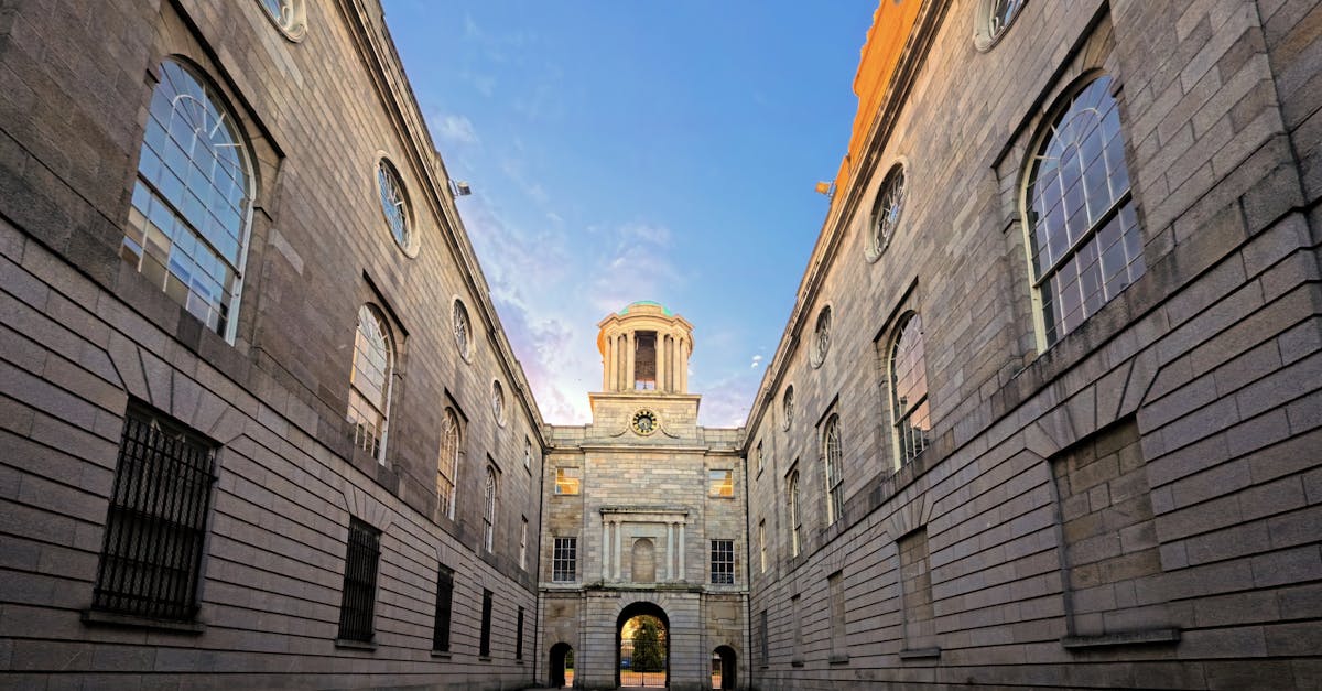 Symmetrical view of a historic building alley under a colorful dawn sky, showcasing classic architecture.