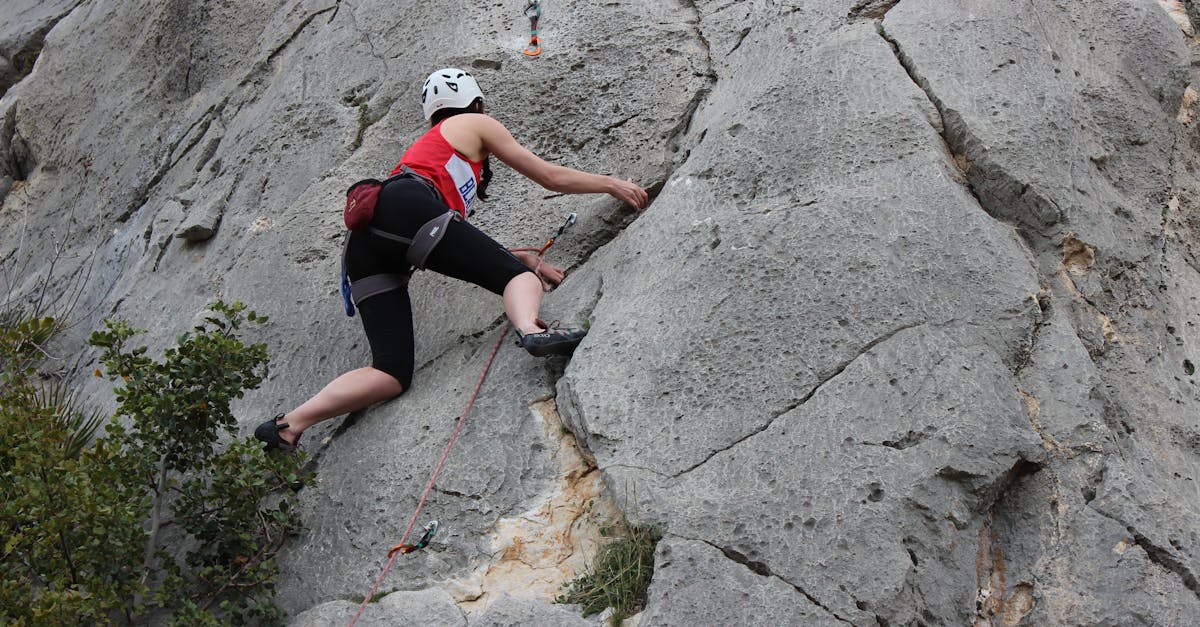 A climber ascends a rugged cliff face in El Chorro, Andalusia, Spain, capturing adventure and skill.