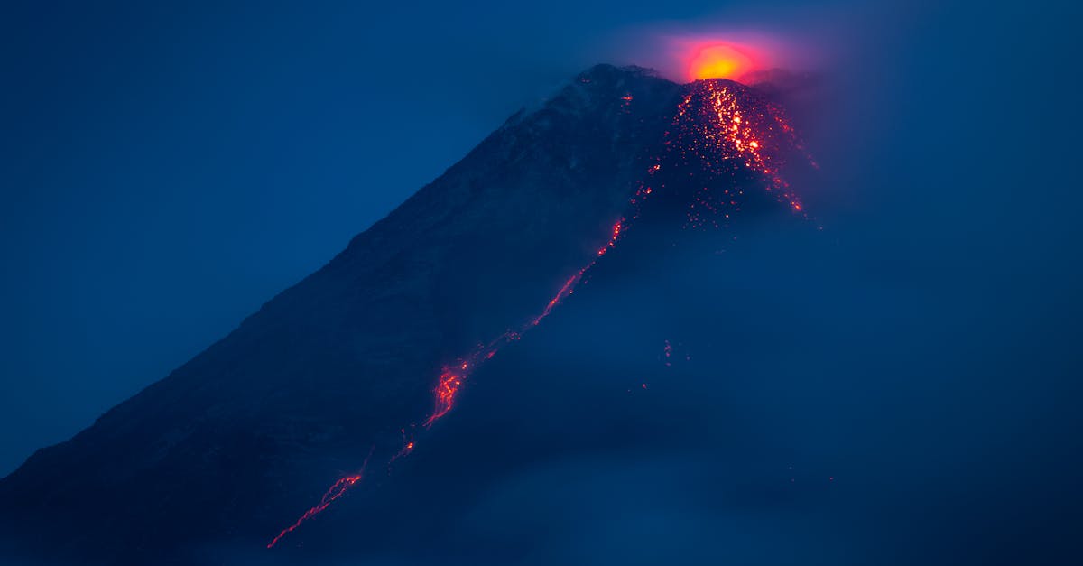 Stunning night view of Mayon Volcano's eruption with glowing lava and ash clouds in the Philippines.