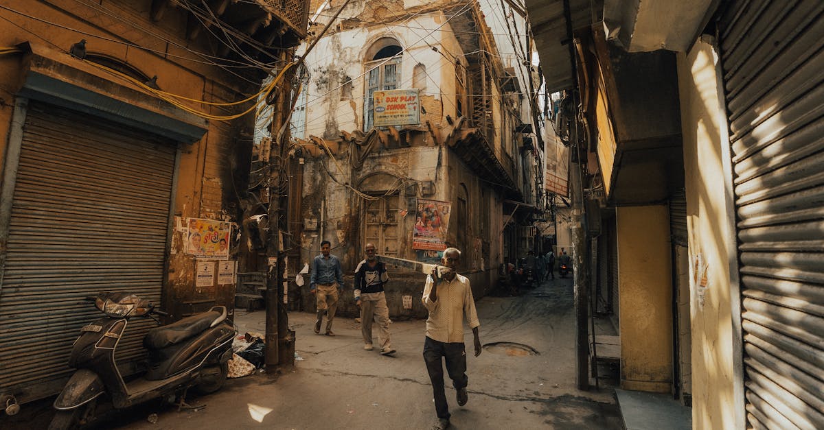 A sunny day in an old Indian street showcasing rustic architecture and daily life.