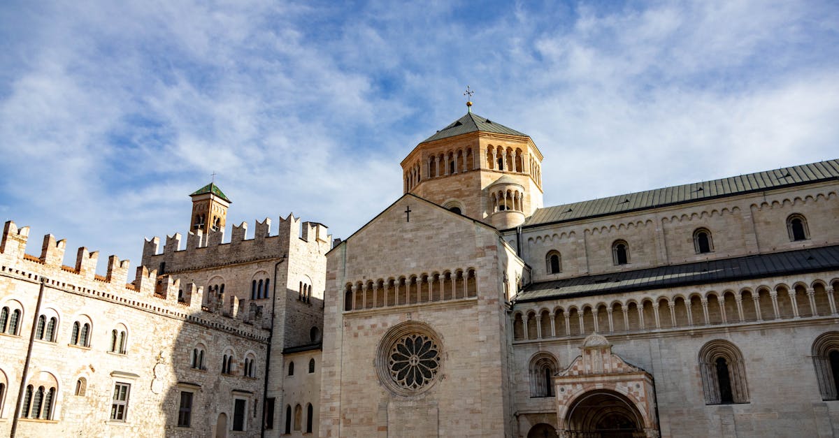 Panoramic view of the iconic Trento Cathedral under a clear blue sky.