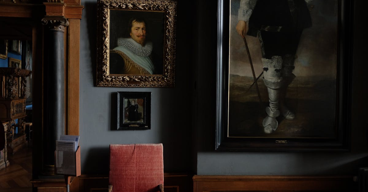 Interior of modern art gallery with portraits in cozy frames hanging on blue wall near comfy old chair