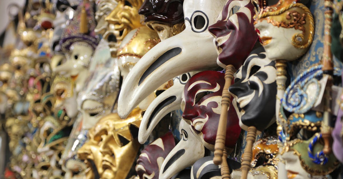 Soft focus of amazing ornamental masks for traditional Venetian festival hanging on wall in rows for sale in local market