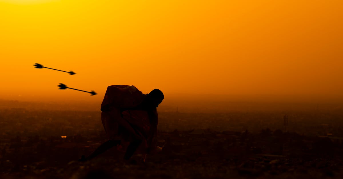 Silhouette of a man running at sunset with arrows in the foreground, creating a dynamic scene.