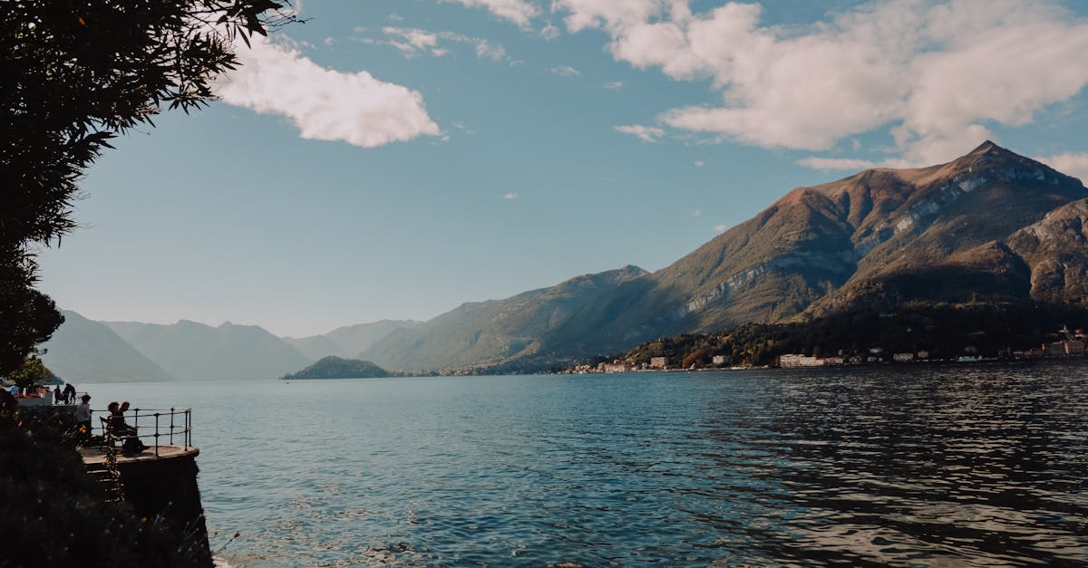 Beautiful day at Lake Como in Italy with mountains, clear sky, and serene waters.