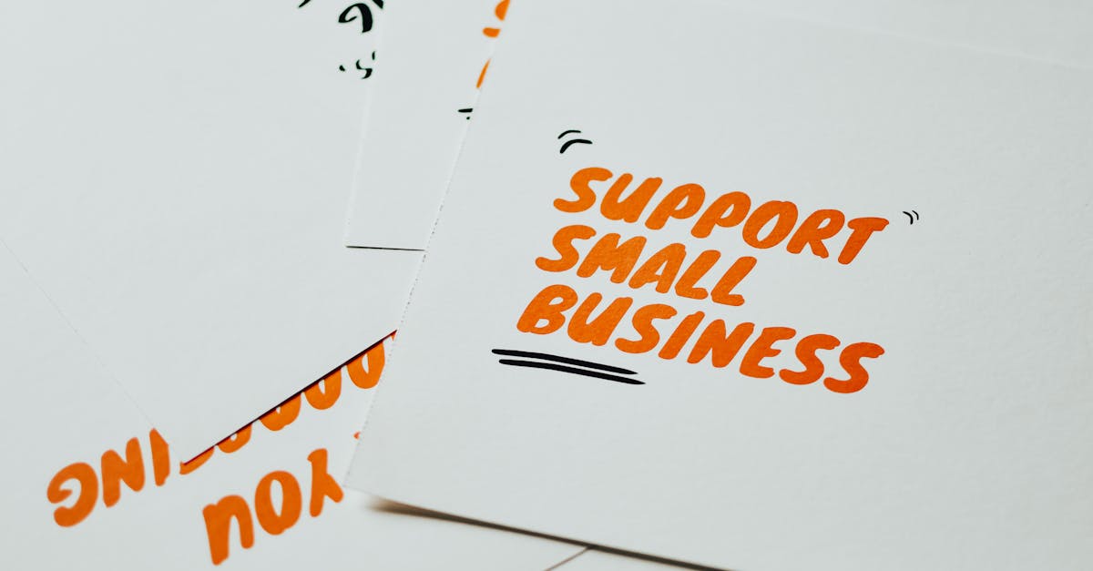 Close-up of motivational cards promoting support for small business on white background.