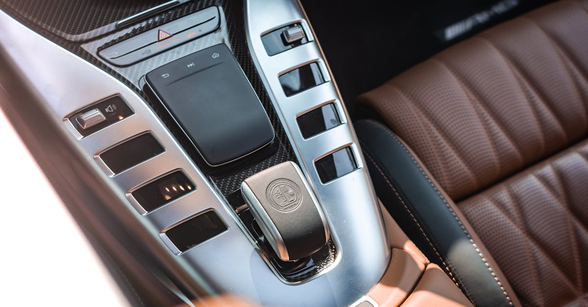 Close-up view of a luxurious car interior highlighting the sleek console and leather seats.