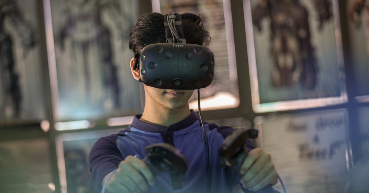 A young man using a VR headset and controllers for an immersive gaming experience indoors.
