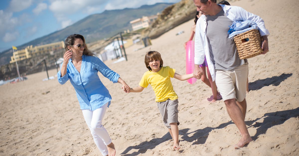 A joyful family strolls along a sunny beach in Portugal, enjoying quality time together.