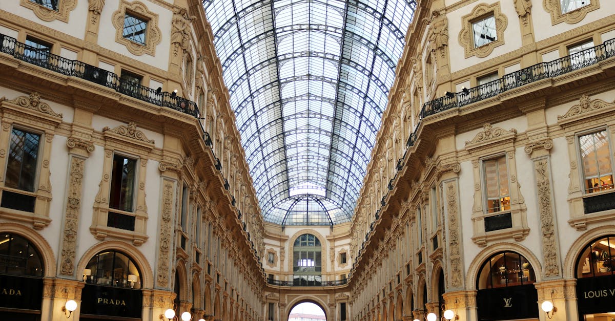 Stunning low-angle view of Galleria Vittorio Emanuele II's ornate interior architecture.